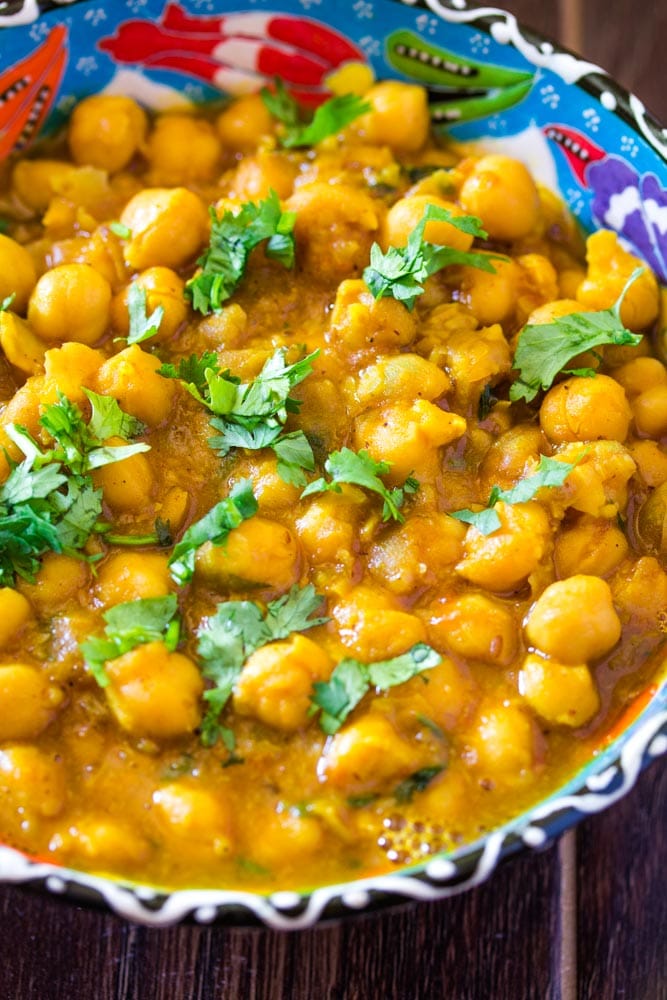 Close up of chana masala in blue bowl.