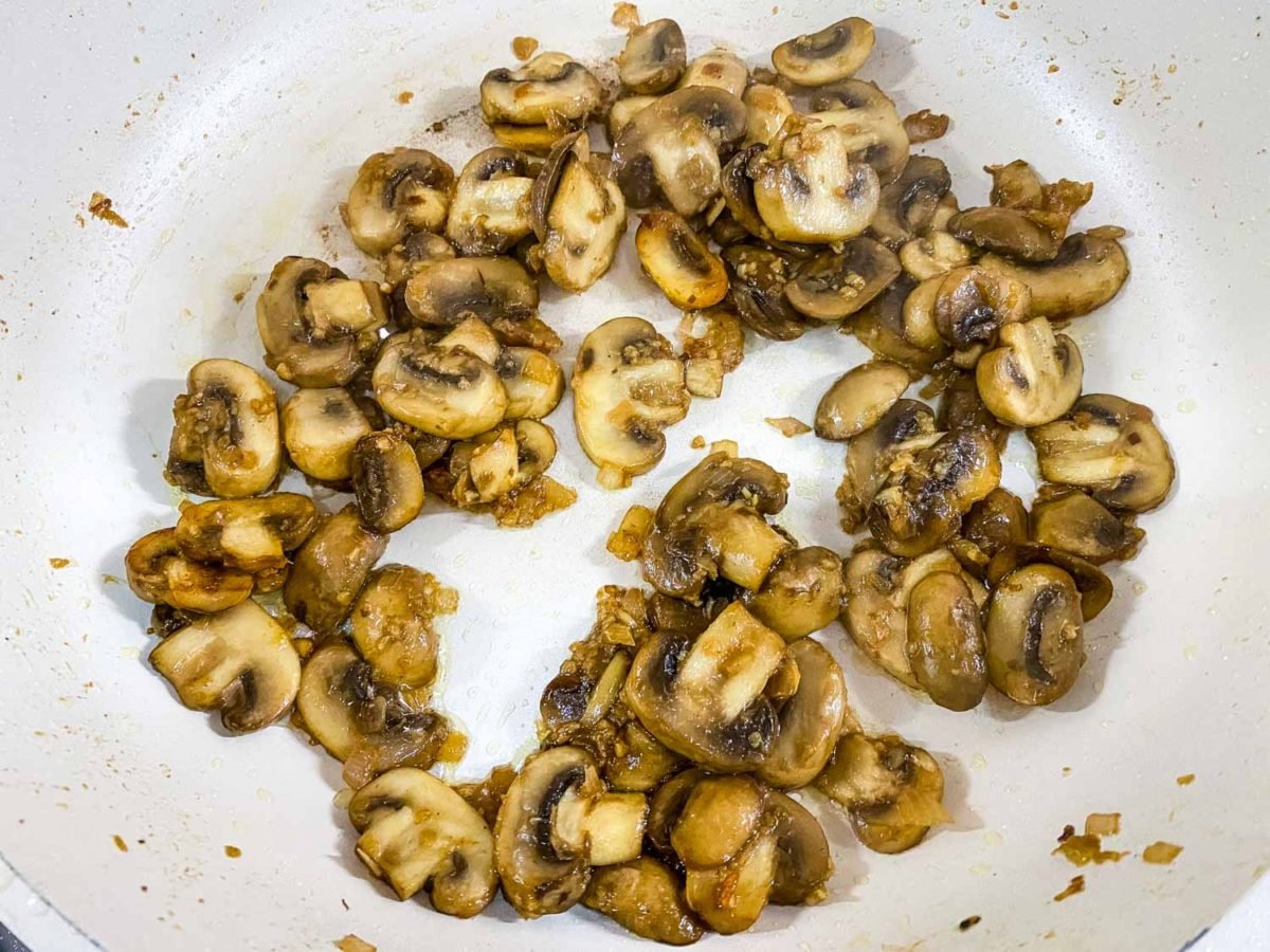 mushrooms, garlic and onions that have been sautéed to a golden brown and have absorbed all cooking oil in a white pan