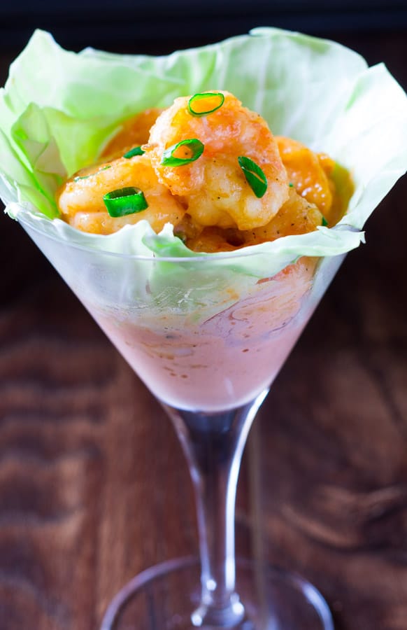 Dynamite Shrimp on a bed of lettuce served in a tall glass.