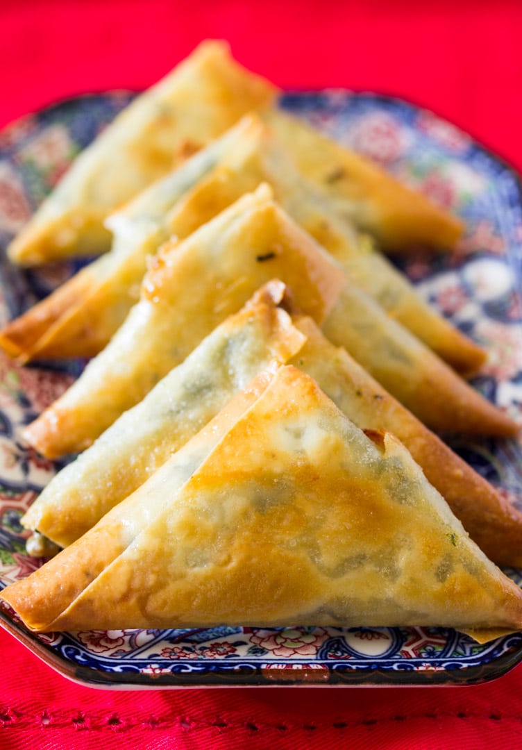 A plate of baked spinach and feta cheese samosa