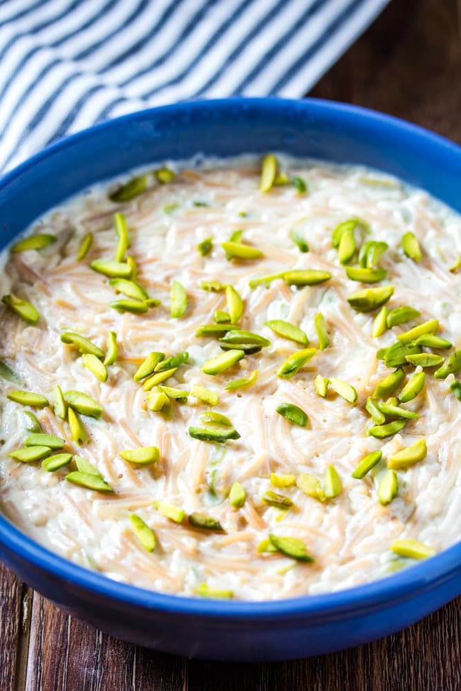 Seviyan Kheer served in bright blue bowl topped with pistachios.