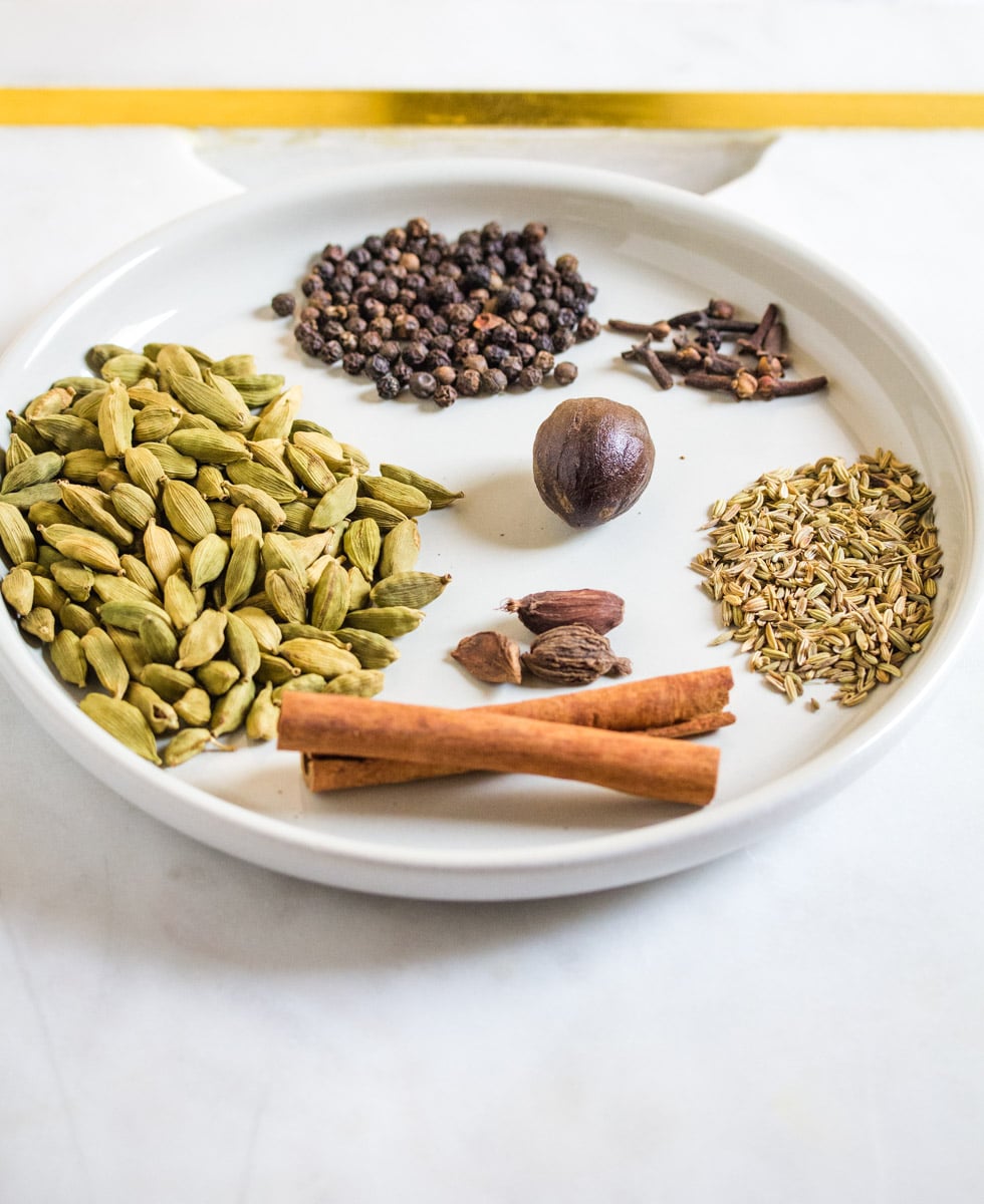 Whole spices on a white plate. 