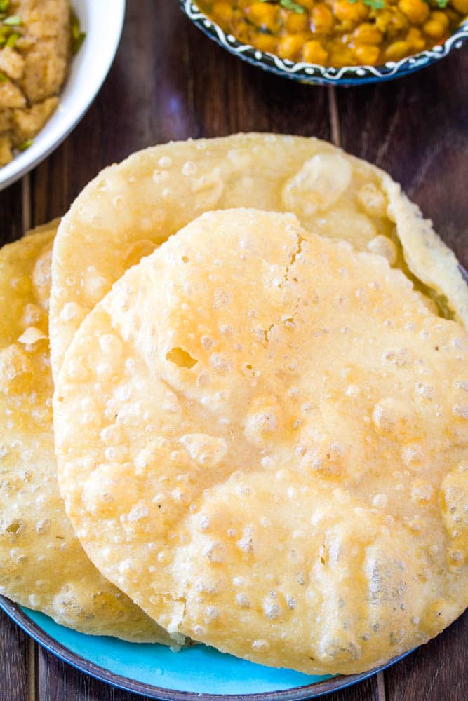 crispy soft poori served on blue plate 