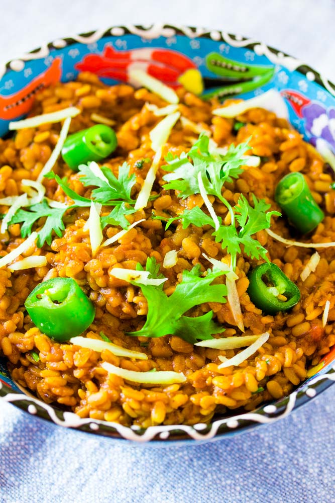 Daal Mash Served in a blue bowl topped with green chillies and coriander