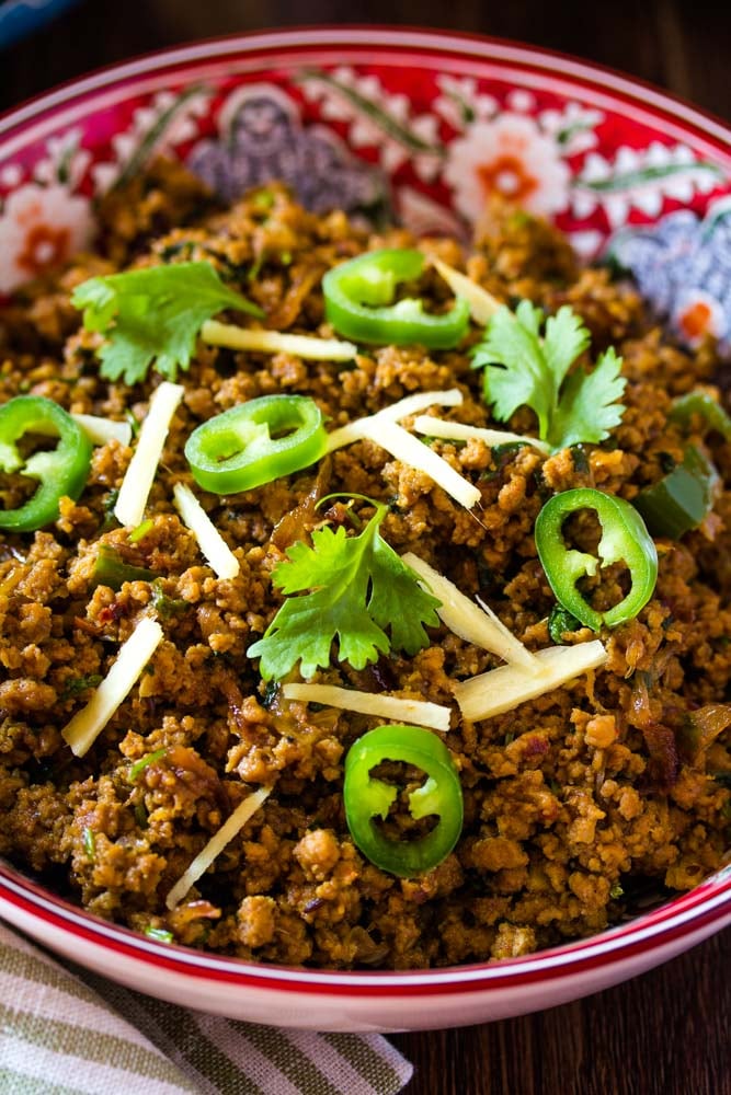 A close up shot of keema topped with fresh garnishes.