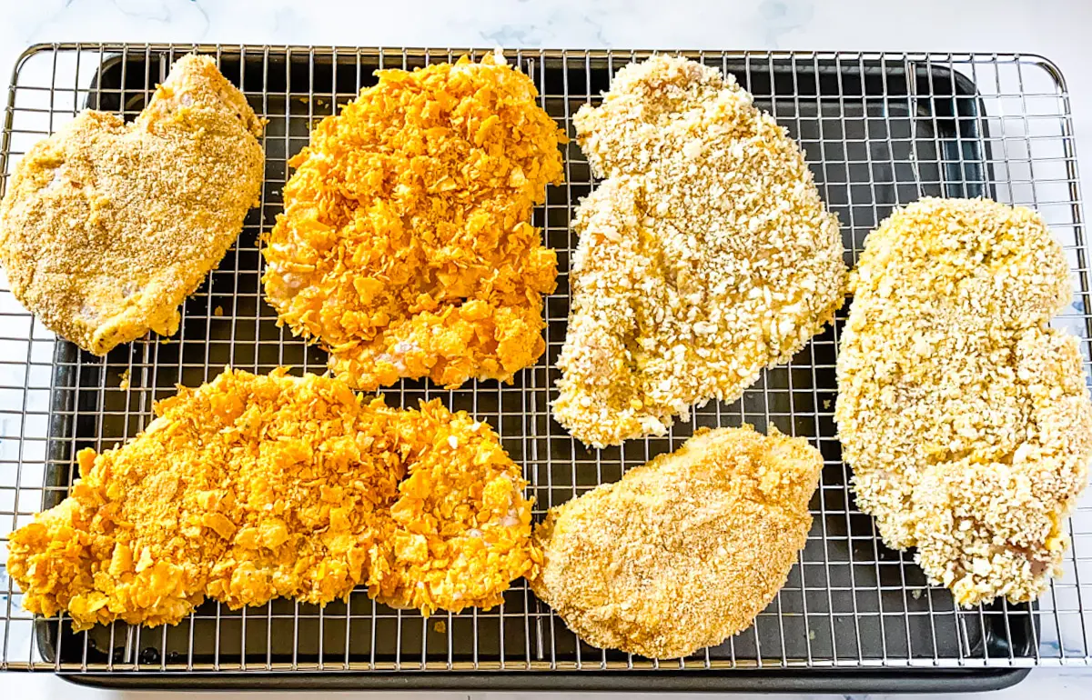 breaded chicken cutlets placed on a baking rack.