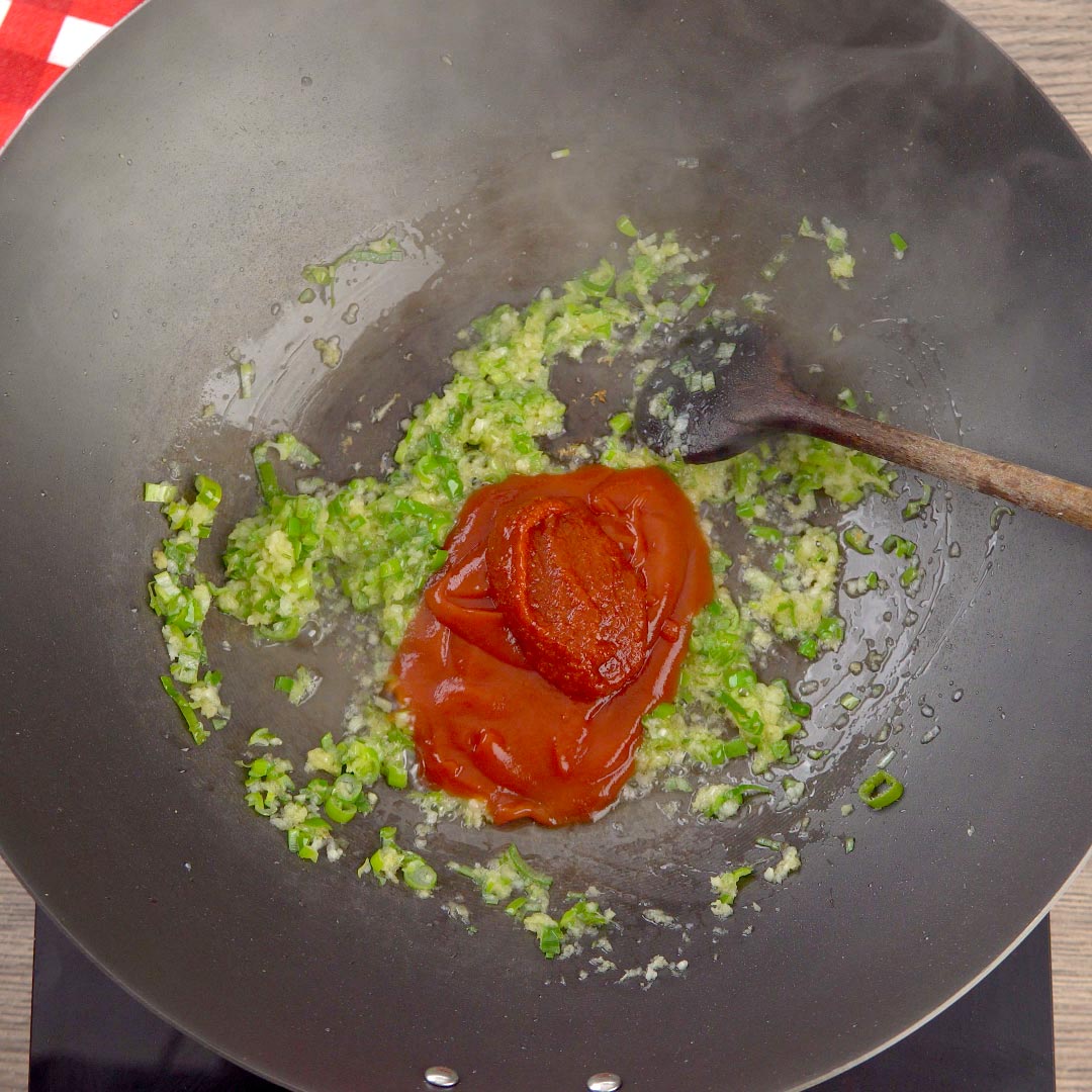 ketchup added to wok with green onion mixture