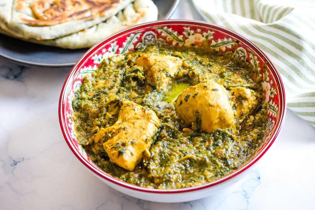 Bowl of chicken spinach curry.