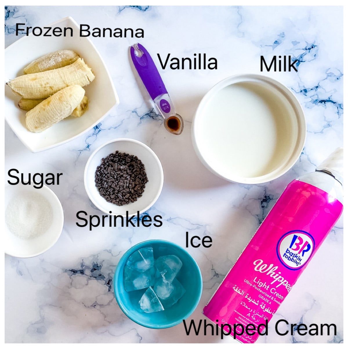 picture of ingredients needed to make banana milkshake laid out on a white backdrop.