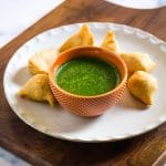 Easy Indian green chutney served in a small textured orange bowl.