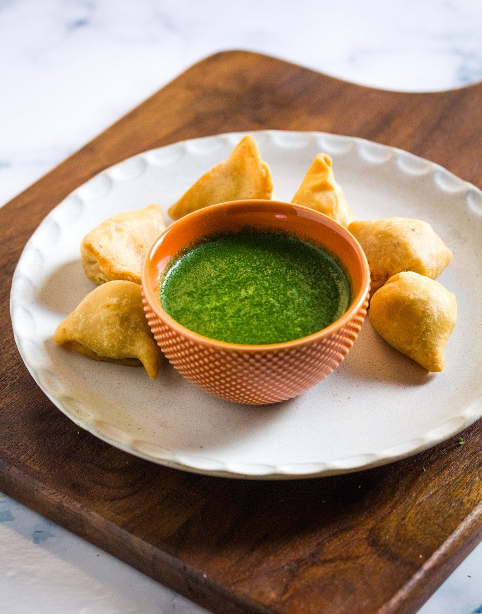 Easy Indian green chutney served in a small textured orange bowl.