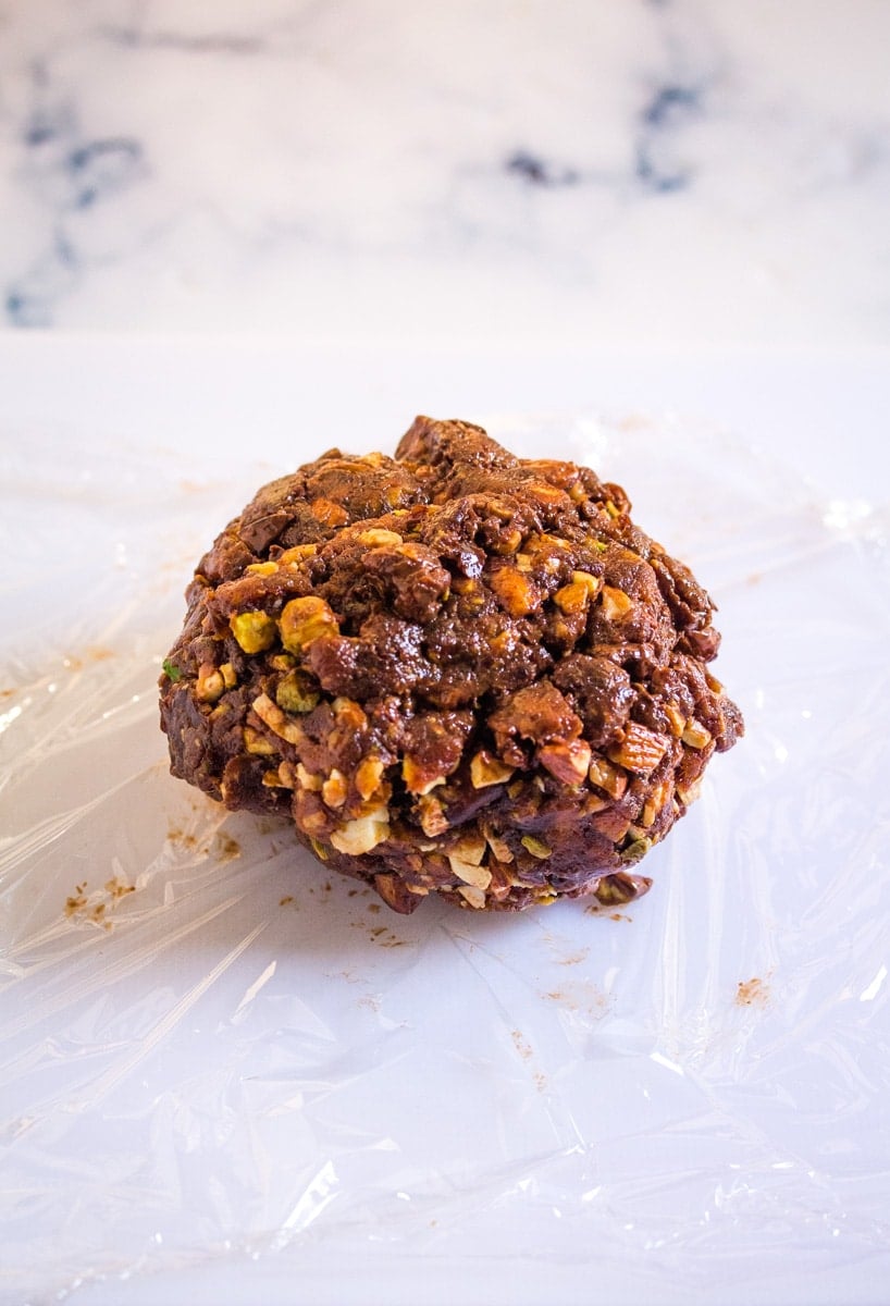 Mixture for date roll formed into a ball and placed a on sheet of cling film.