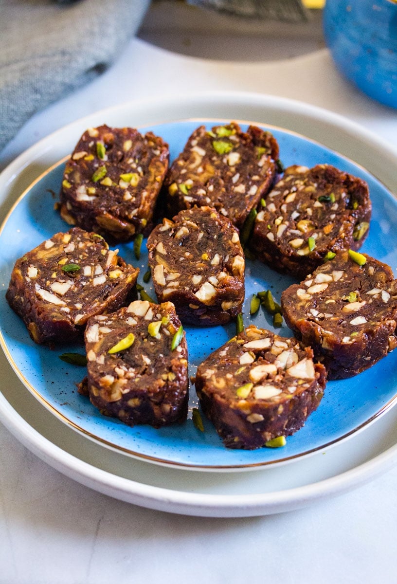 Slices of date roll served on a light blue plate.