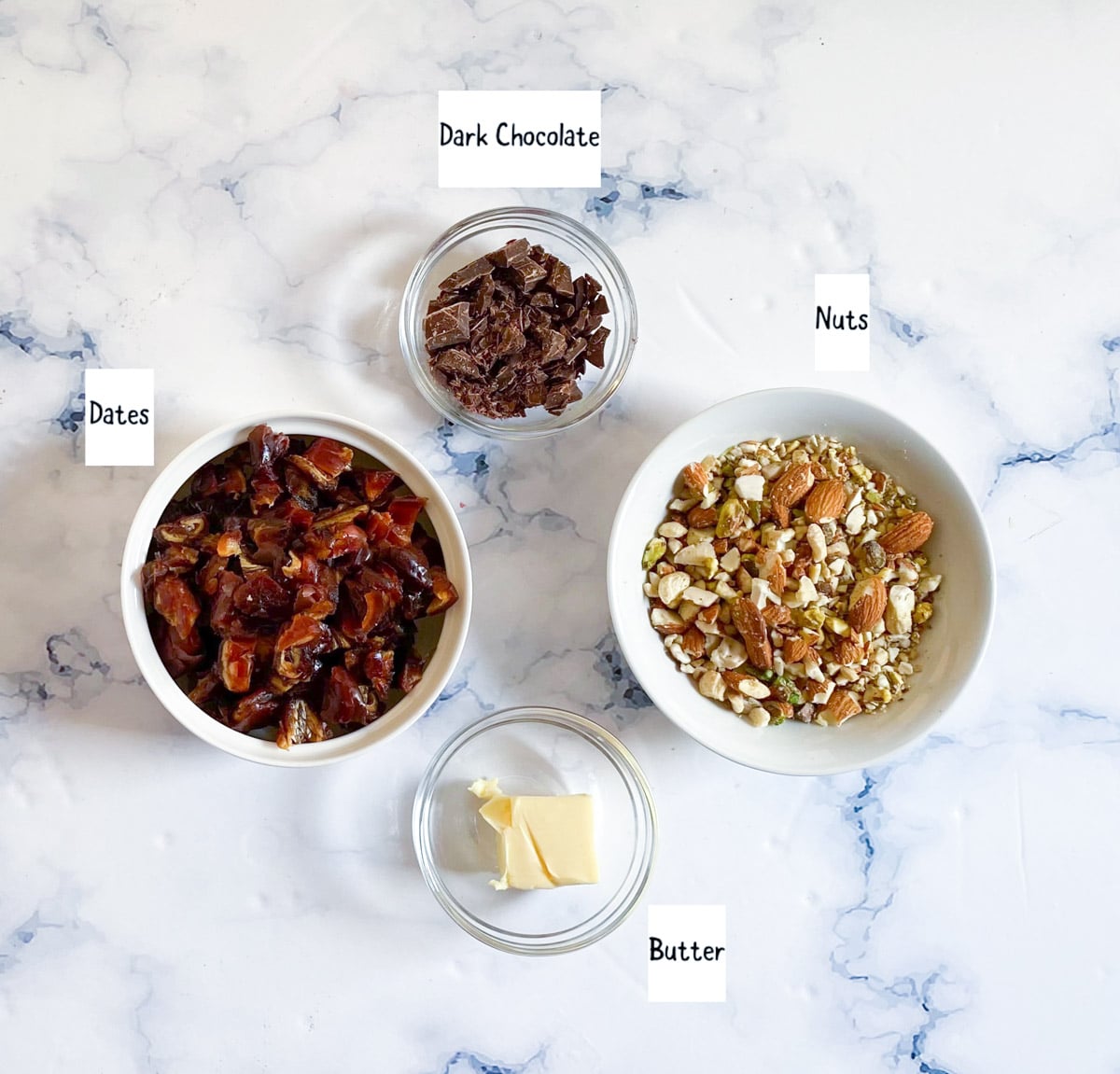 Ingredients for date roll placed on a white backdrop.