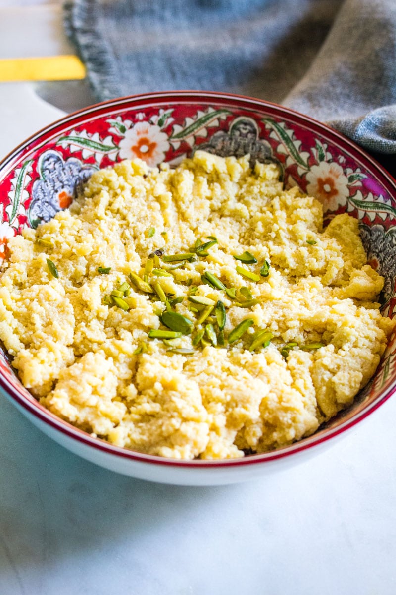 A close up shot of mawa served in a red patterned bowl.