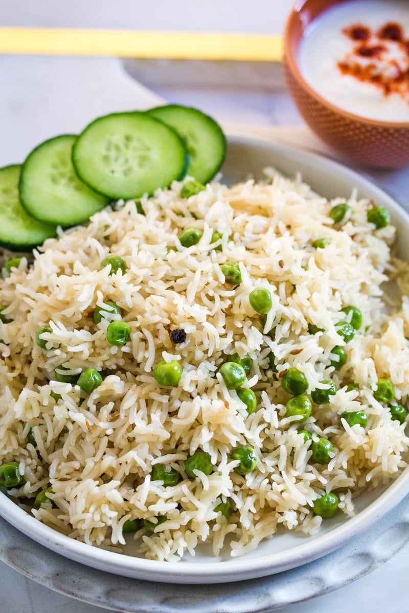 A close up shot of peas pulao made with basmati rice and whole spices.