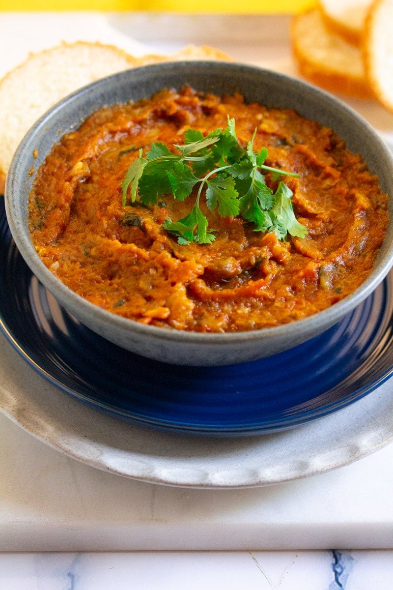 Zaalouk dip served in a grey bowl and garnished with fresh coriander.