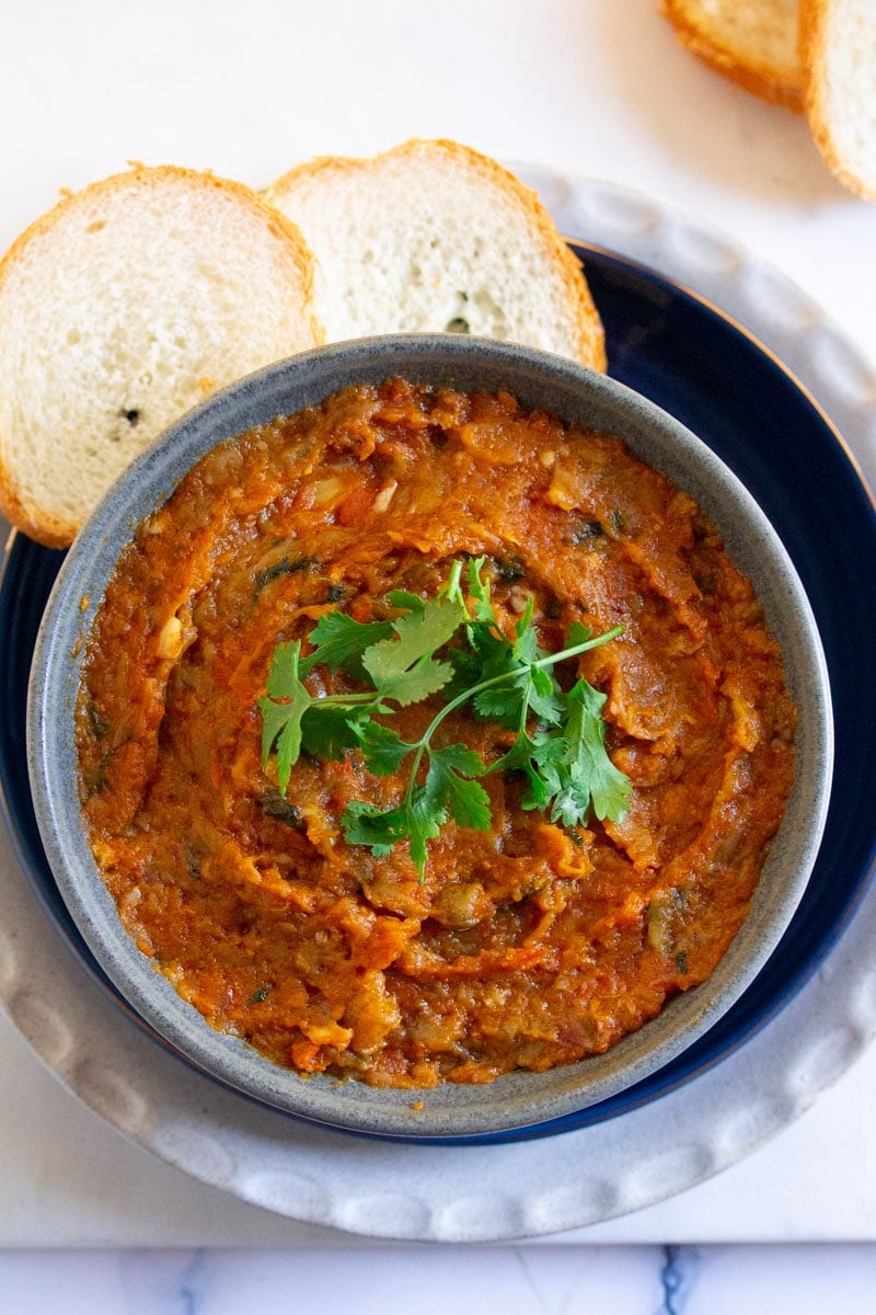 Overhead shot of moroccan eggplant salad served with bread.