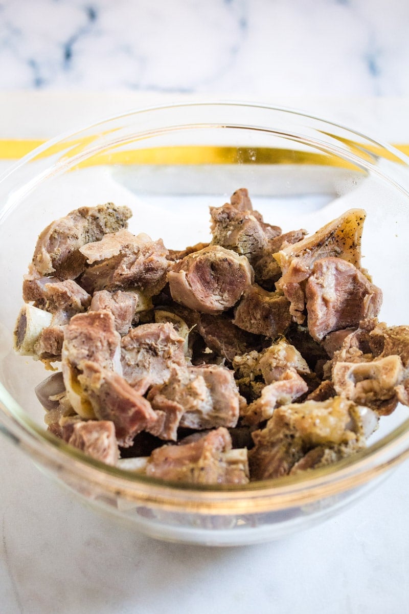 Mutton pieces cooked to 70% in a glass mixing bowl.