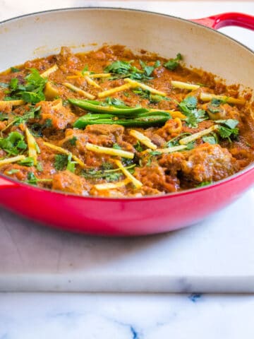 Mutton Karahi topped with fresh ginger, coriander, and green chilies.