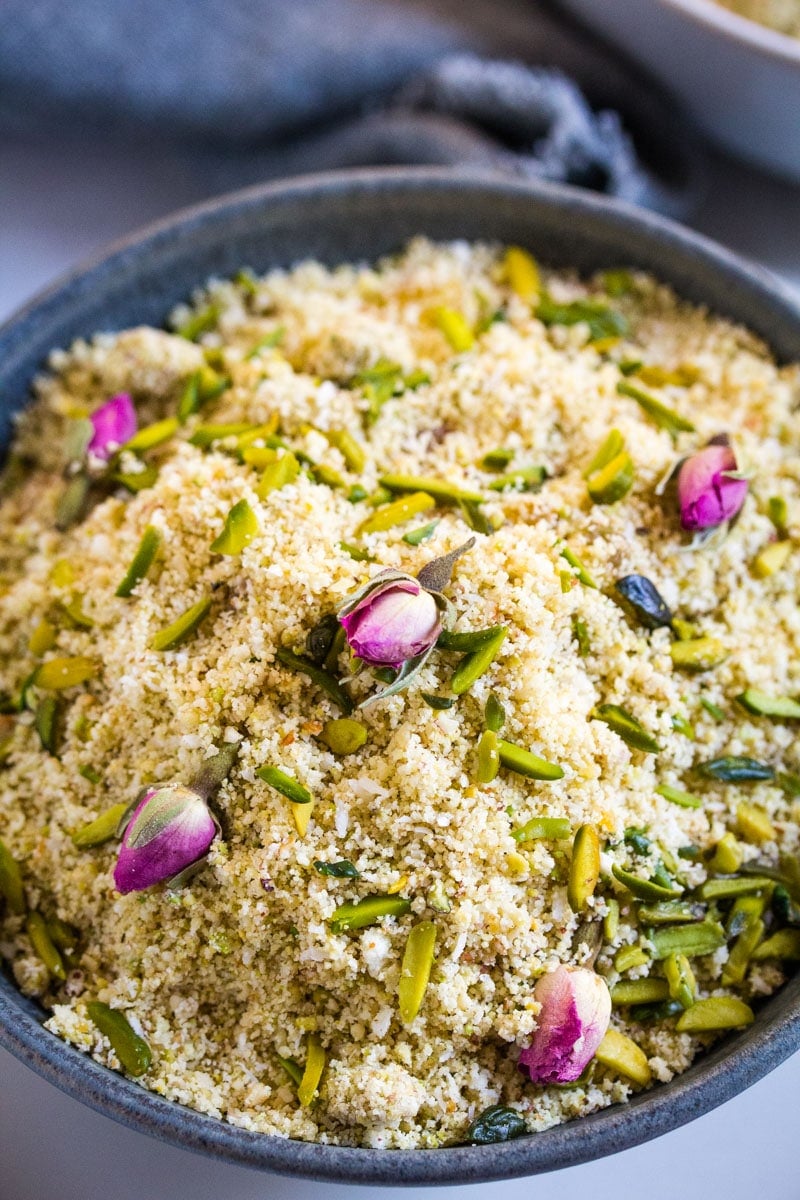 A close up shot of panjiri in a dark grey bowl.