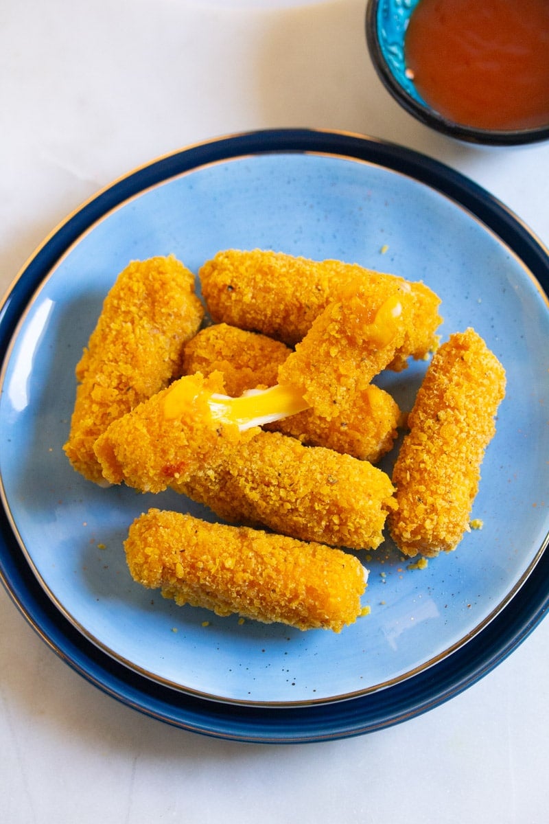 Doritos cheese sticks broken in half with cheese oozing out.
