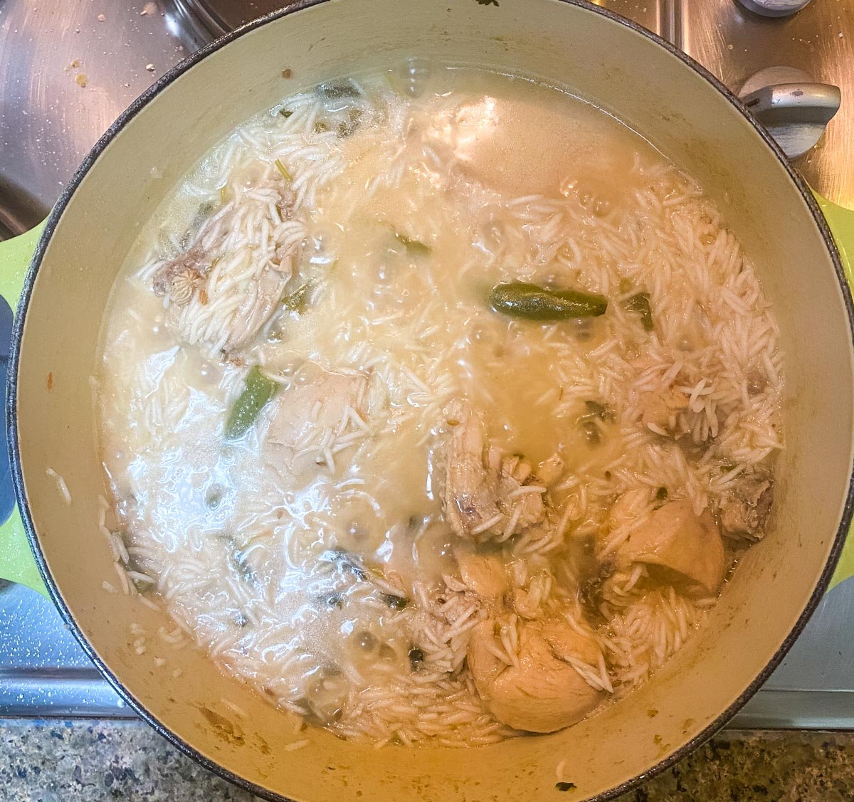 Almost cooked chicken pulao ready to be steamed on low heat.