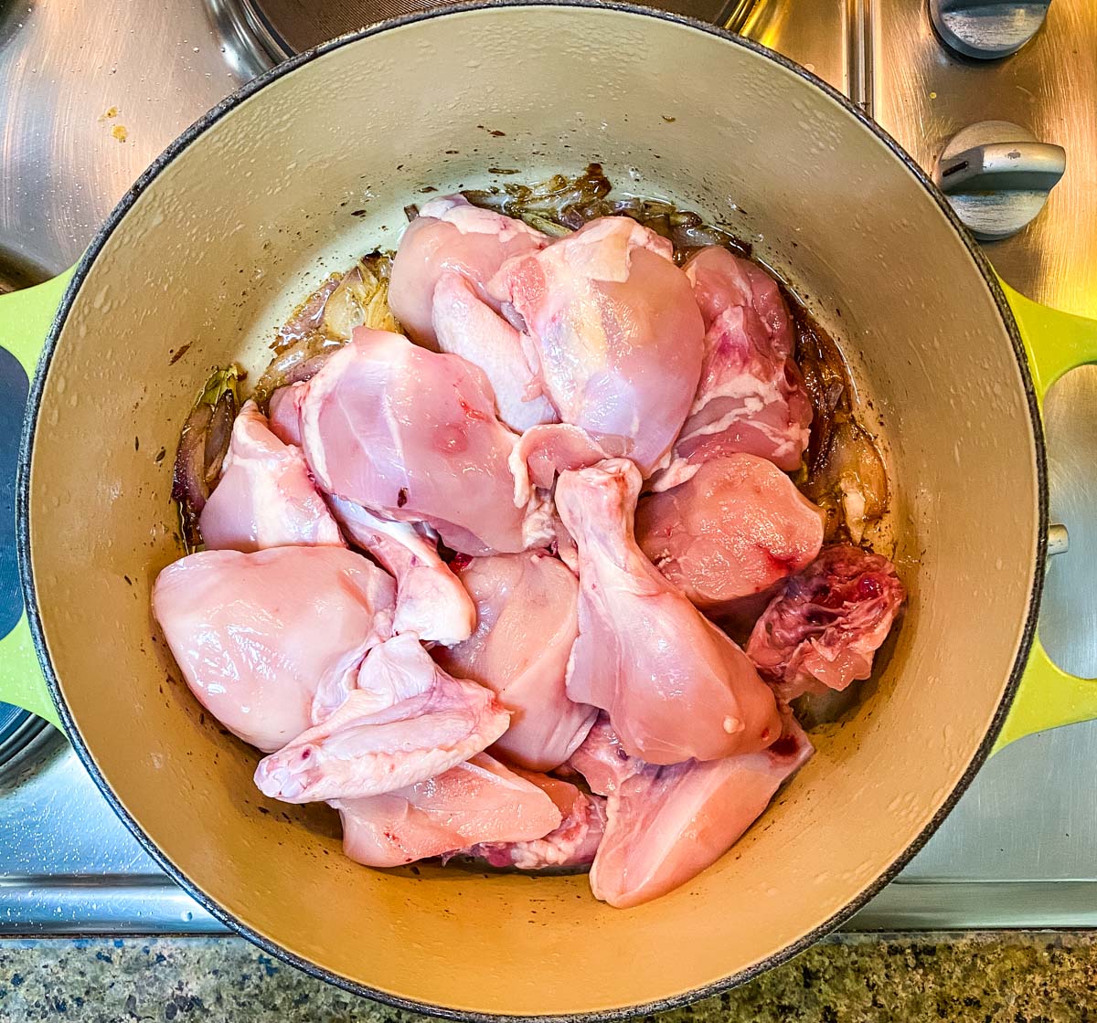 Curry cut chicken in a dutch oven pot.