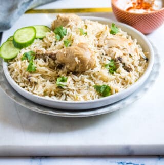 Pulao Chicken served on a light grey plate.