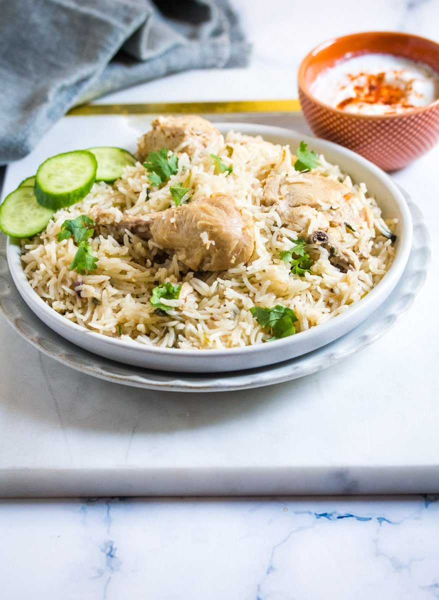 Pulao Chicken served on a light grey plate.