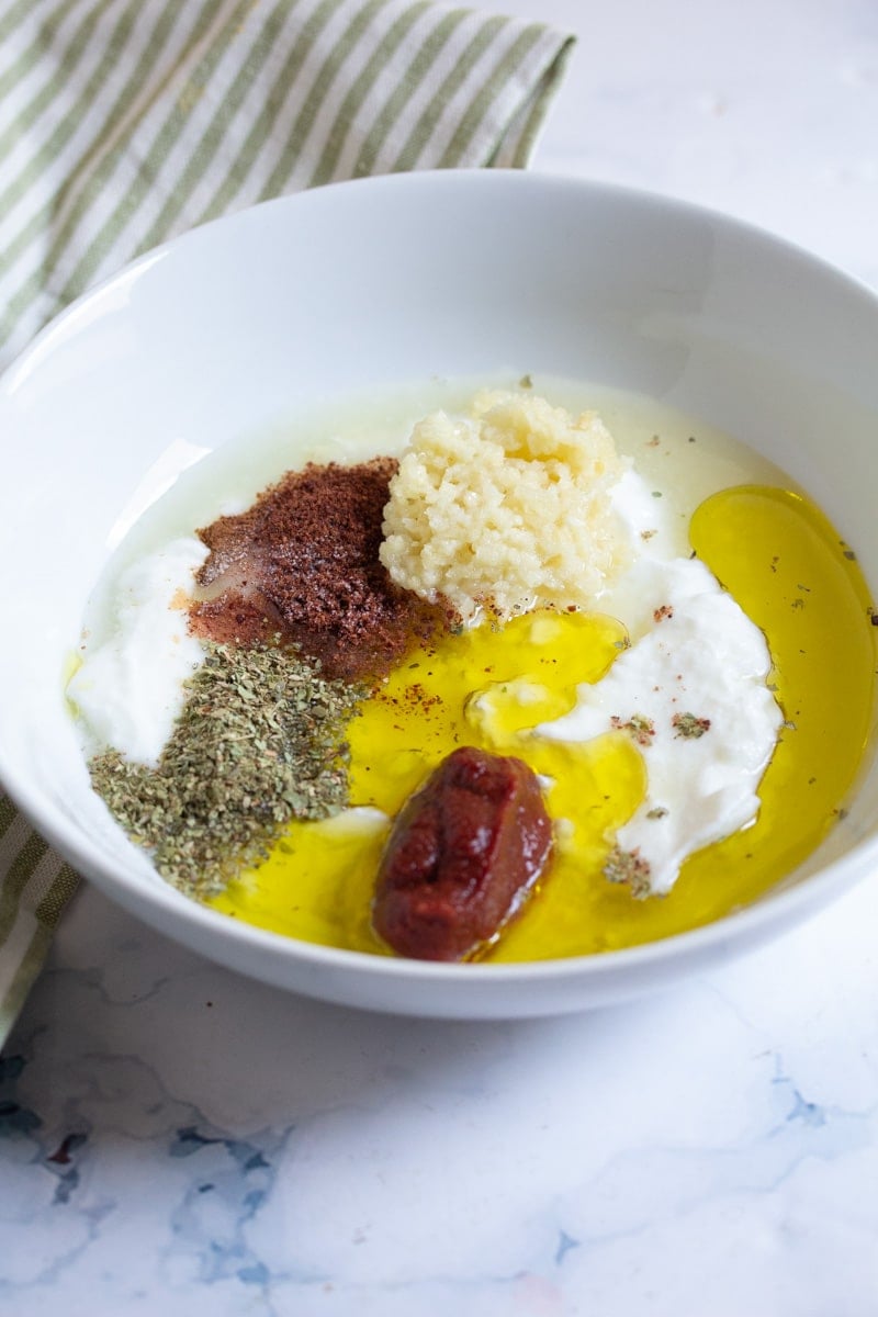 Marinade ingredients in a white bowl, ready to be mixed.