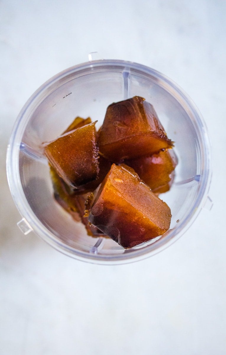 Frozen cold brew ice cubes in a blender.