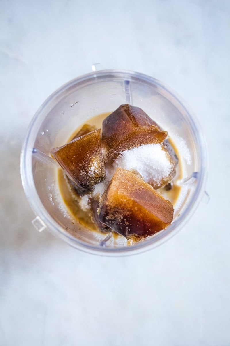 Sugar, milk, vanilla, and frozen coffee ice cubes in a blender.