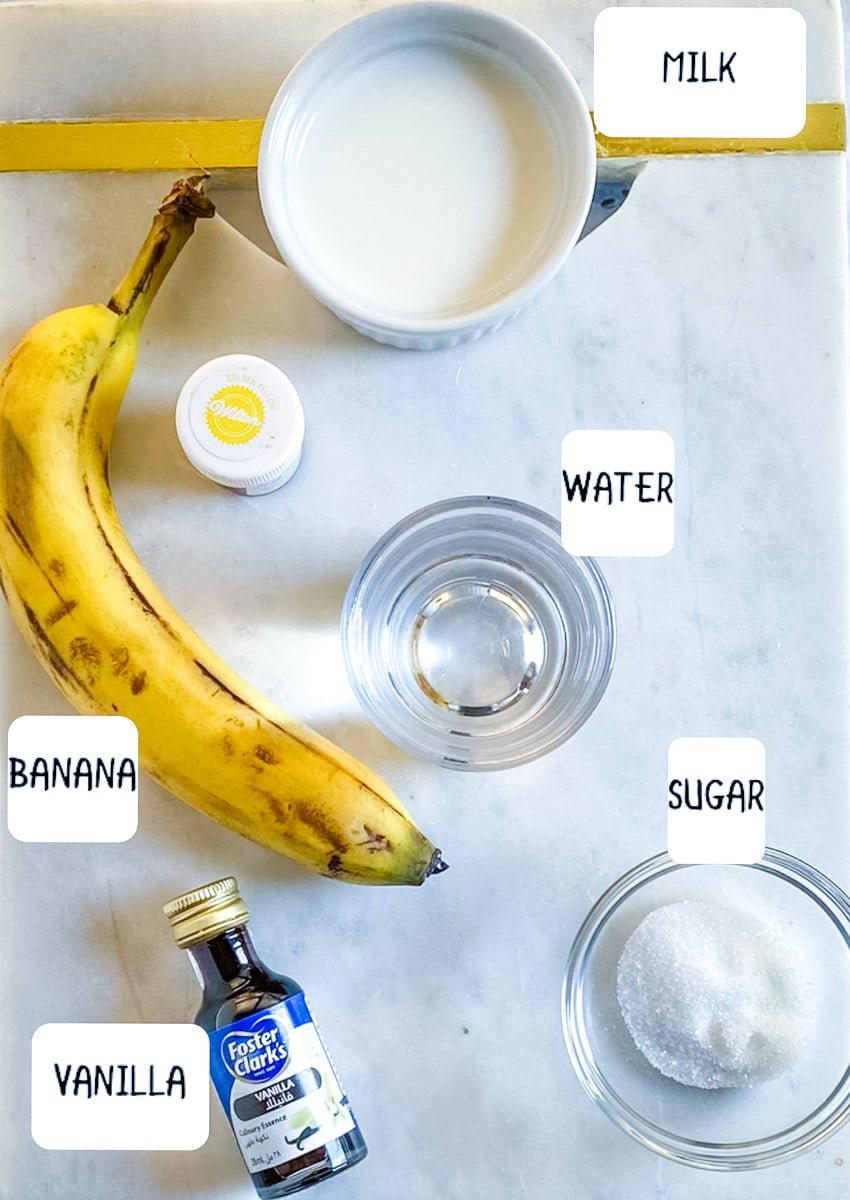 Ingredients for Korean Banana Milk placed on a white marble slab.