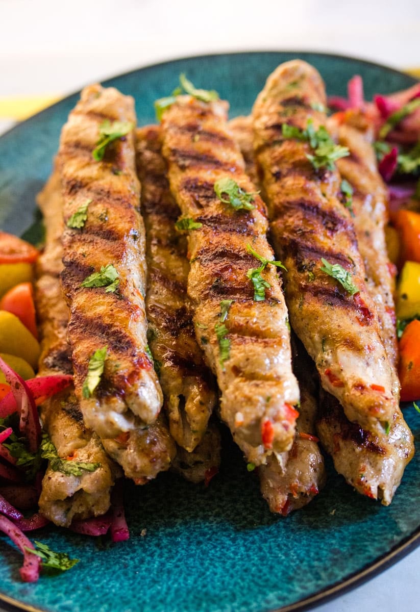 Close up of chicken adana with vegetables.