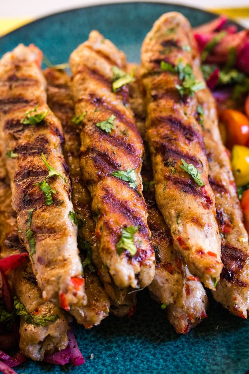 Close up of chicken adana with vegetables.