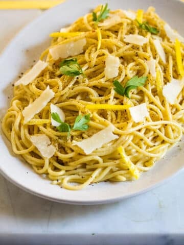 Lemon pepper pasta served on a white platter.